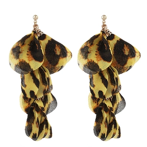 Close-up of leopard print fabric petal earrings with gold stud and layered fringe details