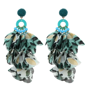 Detail of bohemian fabric flower earrings with leopard print petals and turquoise beads
