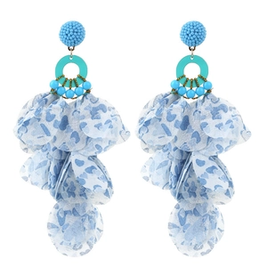Macro shot of blue handmade fabric flower earrings with long layered tassel petals