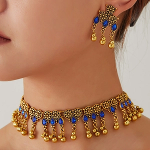Bohemian gold jewelry set with vintage blue stones and ethnic tassel details