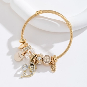 Bracelet en fil d'acier tressé doré avec breloques dauphin en cristal et trèfle