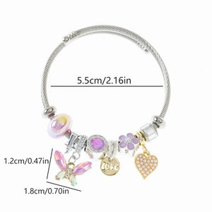 Detail view of steel bead bracelet featuring pink butterfly charm and Love heart pendant