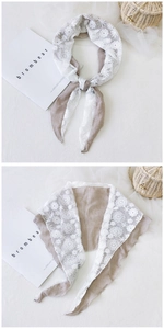 Detail of Korean style floral lace and linen patchwork triangular scarf in brown