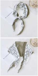 Detail of olive green cotton linen scarf with white floral crochet lace trim edges