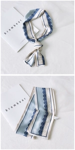 Detail view of a long leopard print silk scarf with blue lace edges and satin finish