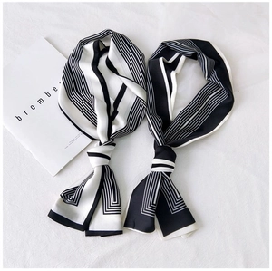 Detail shot of black and white skinny scarves with minimalist geometric stripes