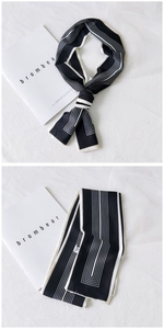 Detail of a black and white striped narrow silk scarf with premium geometric patterns