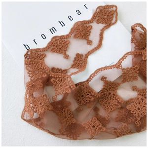Close-up of brown floral embroidery on delicate lace mesh for a stylish neck scarf