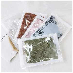 Detailed view of five colorful embroidered lace scarves in elegant individual packaging