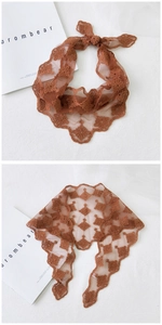 Close-up of brown floral embroidered lace triangle scarf with scalloped edges