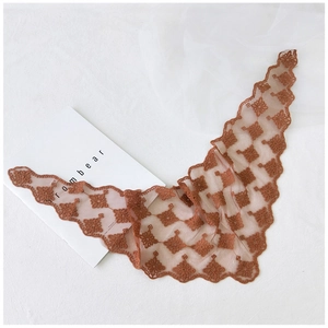 Close-up of terracotta lace triangle scarf with floral embroidery and scalloped edges