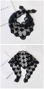 Detail of black floral lace triangle scarf with delicate mesh embroidery and wavy edges