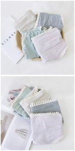 Detailed view of layered cotton linen plaid scarves with delicate white lace edges