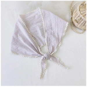 Detail of light purple gingham cotton scarf with white lace trim and knotted design