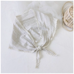 Detailed view of grey plaid cotton linen scarf with elegant lace trim and tied knot design