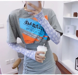 Detail of light purple ice silk sun protection sleeves with white floral pattern on wrist