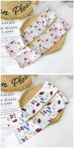 Detail of fruit print cooling sun sleeves with strawberry and daisy floral patterns