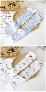 Detail of floral and cartoon cooling arm sleeves for sun protection with a silky texture