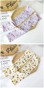 Detail view of cartoon fruit ice silk arm sleeves featuring strawberry and daisy patterns