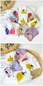 Detail of fruit print cooling sun protection arm sleeves with strawberry and peach patterns