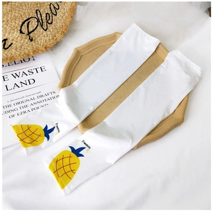 Detailed view of white ice silk sun sleeves with yellow pineapple pattern and text