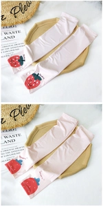 Close-up of pink sun protection arm sleeves with cute strawberry print and soft fabric