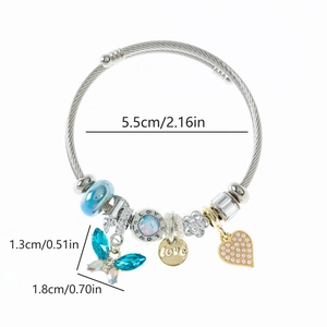 Detail of steel cable bracelet with blue crystal butterfly and gold love charms