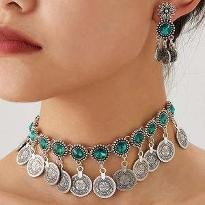 Bohemian vintage jewelry set with emerald green gems and silver coin pendants