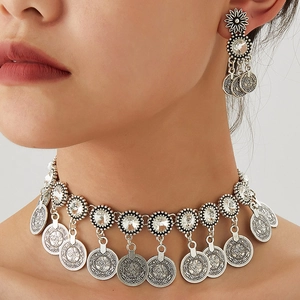 Retro Middle Eastern jewelry set with sparkling coin pendants and floral earrings on model