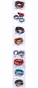 Detail von mehrlagigen Boho-Perlenarmbändern mit Eiffelturm- und Flügelanhängern