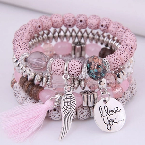 Bohemian multi-layer beaded bracelet set with pink tassels and heart charm in white background