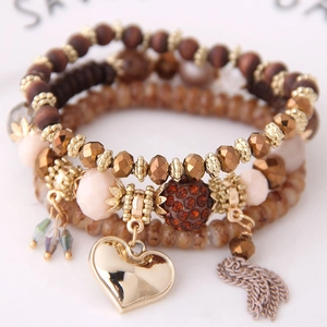 Bohemian multilayer beaded bracelet featuring crystal heart pendant and tassel details