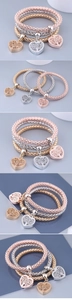 Detailed view of three-piece set elastic popcorn bracelets with hollow tree of life charms