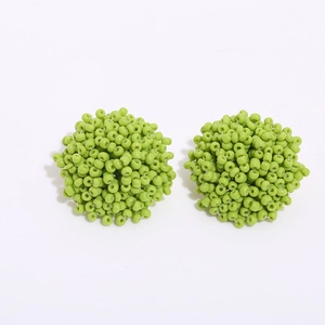 Bohemian handmade light green beaded spherical cluster stud earrings on white background