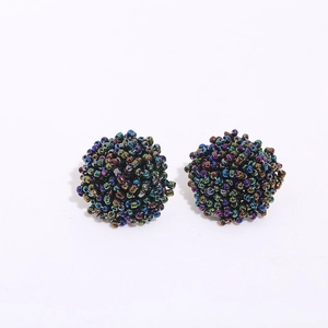 Macro shot of handmade iridescent glass bead cluster earrings with colorful metallic finish