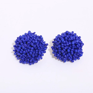 Top view of handmade deep blue beaded spherical earrings with a glossy finish