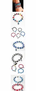 Macro detail of Hamsa Hand charm and blue Evil Eye beaded bracelet with crystal accents