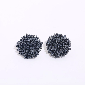 Detailed view of handcrafted dark blue seed bead cluster earrings with unique texture