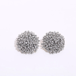 Detailed view of silver handmade beaded cluster earrings featuring textured metallic beads