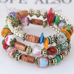 Bohemian multilayer beaded stretch bracelet featuring wood beads and floral charms
