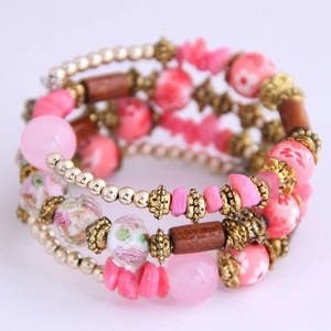 Close-up of bohemian multilayer wrap bracelet with pink beads and wooden accents