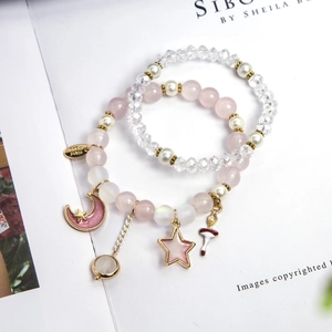 Perlenarmbänder-Set mit rosa Kristallen, Stern- und Mondanhängern sowie Ballerina