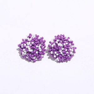 Detailed view of handmade purple and white seed bead cluster earrings in bohemian style