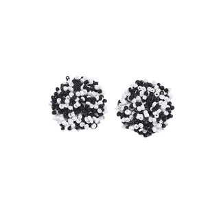 Bohemian black and white seed bead ball stud earrings with intricate woven texture