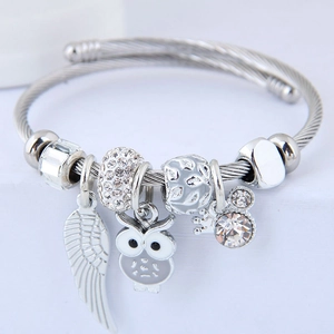 Silver stainless steel cable bangle with owl, feather charms and zircon accents