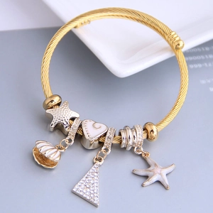 Adjustable golden twisted rope bracelet with nautical charms like starfish and shell