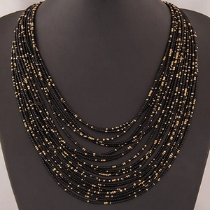 Multilayer bohemian seed bead necklace with black and gold teardrop tiered design