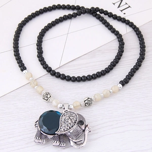 Bohemian long beaded necklace featuring a silver elephant pendant with a deep blue gemstone