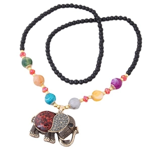 Bohemian long necklace with matte black beads and a vintage elephant pendant in retro style