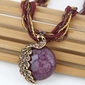 Bohemian retro peacock necklace with purple stone pendant and tassel bead details